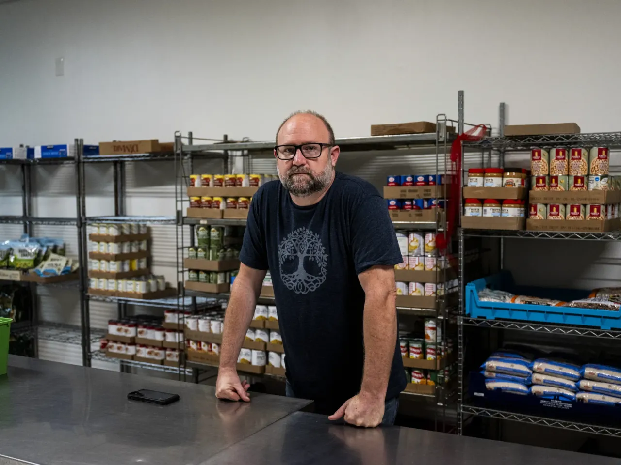 Hunter Demster, a community organizer and co-founder of Vecindarios901, inside of a food pantry in First Congregational Church.