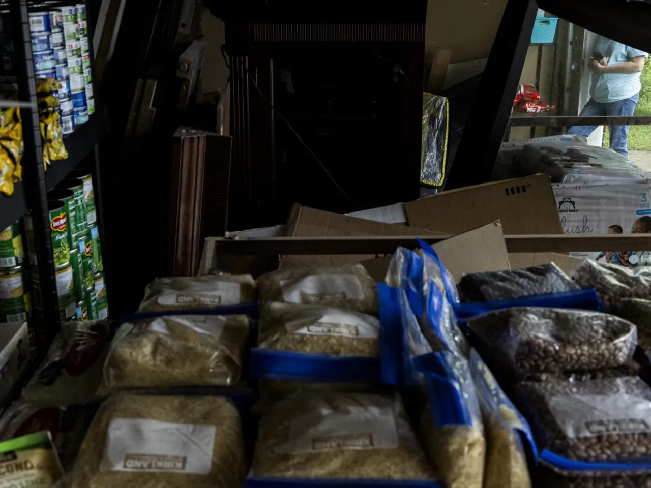 A volunteer delivery person is seen at Amber Hampton's garage in a suburb of Memphis where Hampton runs one of the many "immigrant pantries" in the Memphis area.
