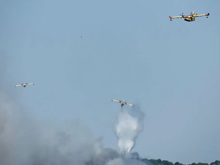 Canadair firefighting aircrafts fight a wildfire burning near Pelayos de la Presa, 65 kilometers west of Madrid, on July 26, 2026.
