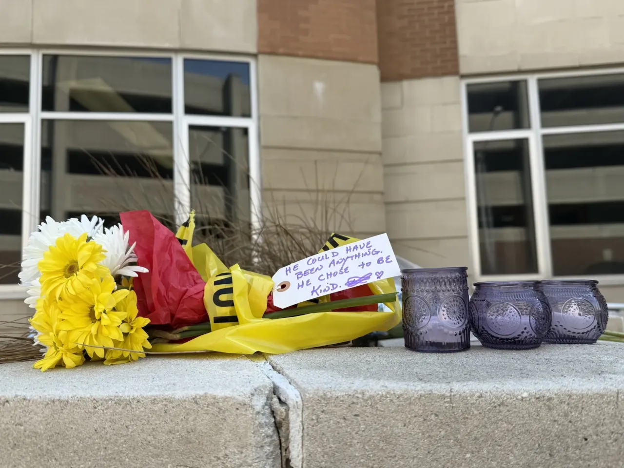 Candles and flowers outside Constant Hall after a student shot and killed ROTC instructor Lt. Col. Brandon Shah and injured two other students. A note attached to the flowers read: "He could have been anything. He chose to be kind."