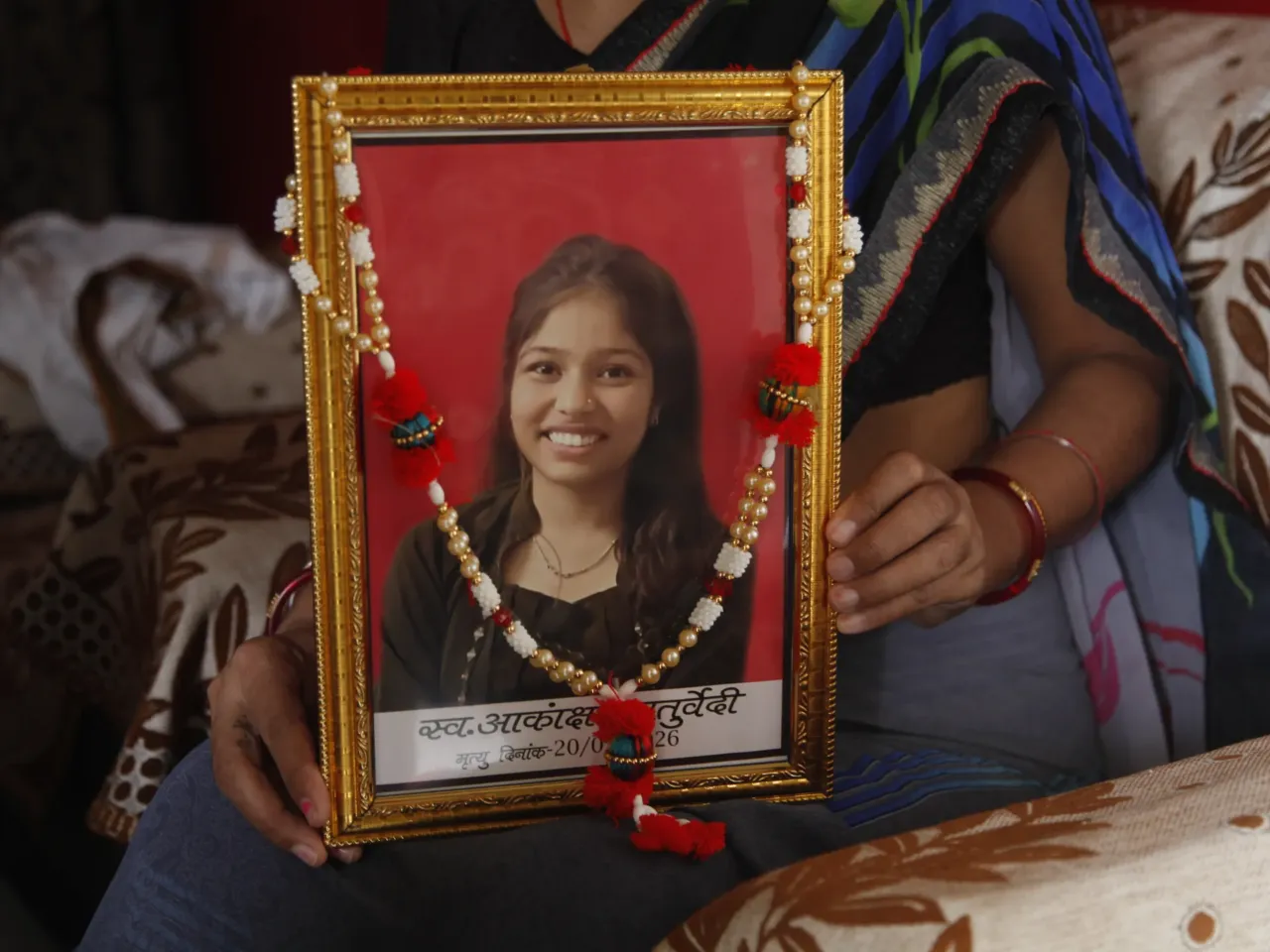 From a mother's grief to a nation's fury: How an exam leak became a political storm 2 A close-up of a photograph of Akanksha Chaturvedi, who was 18 when she took her own life in May.