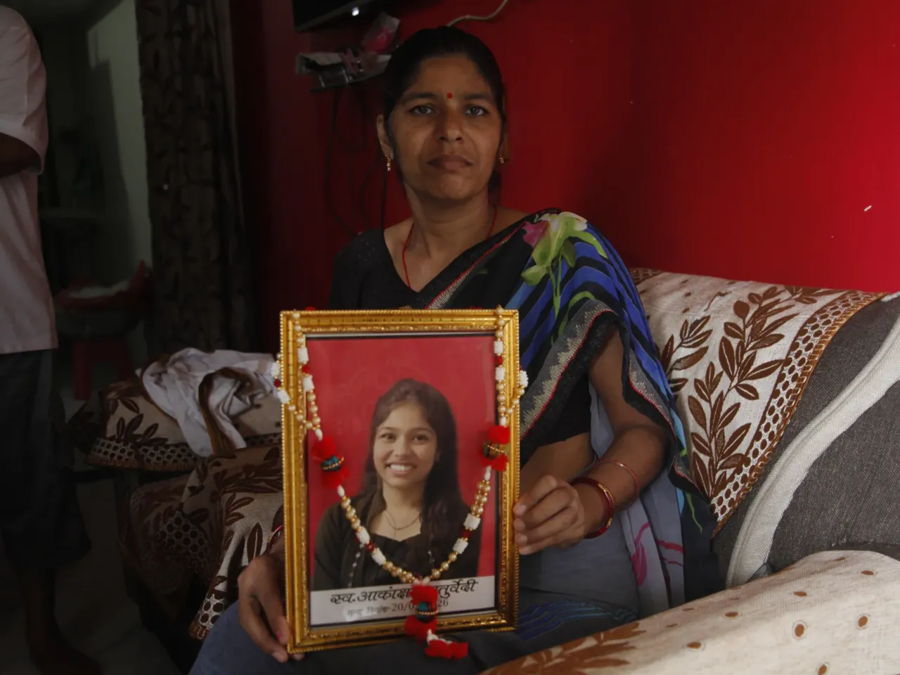 Neelum Chaturvedi holding a picture of her 18-year-old daughter Akanksha, who took her own life in May, soon after authorities cancelled the results of a high-pressure medical exam Akanksha had taken, saying the results had been leaked.