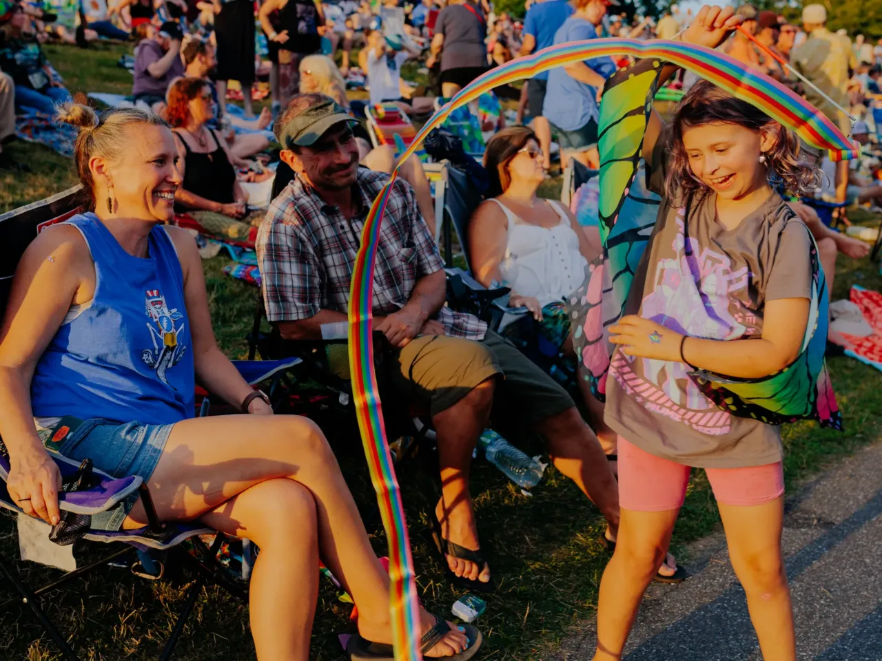 Maggie Ferguson, 9, twirls a ribbon in front of her parents Carrie, 48, and Ken, 49, at All Good Now festival at Merriweather Post Pavilion. Carrie has been a fan of the Grateful Dead, since she was a teenager and has been attending All Good Now since high school. "I just love the community, it's just so much fun. It's all positive. We've brought our daughter to festivals since she was a baby. She's very safe, she loves it, she grew up here. She's 9, she went to her first fest at 5 months old. She's a show girl for sure."