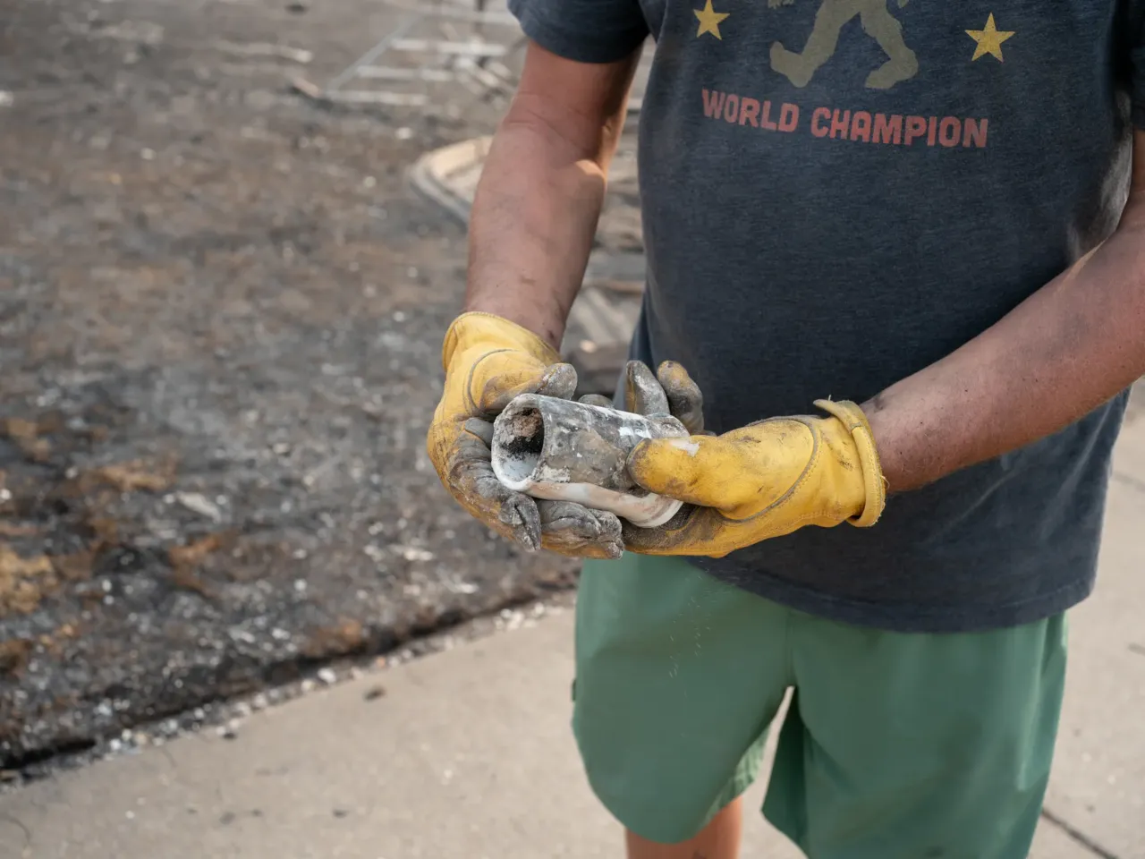 Wildfires in urban areas are more common. That may have helped Spokane 2 Resident TJ Brill displays a cup he is able to pull from the rubble of his home on Thursday. The cup sat next family heirlooms, including World War II medals, he hopes to find.