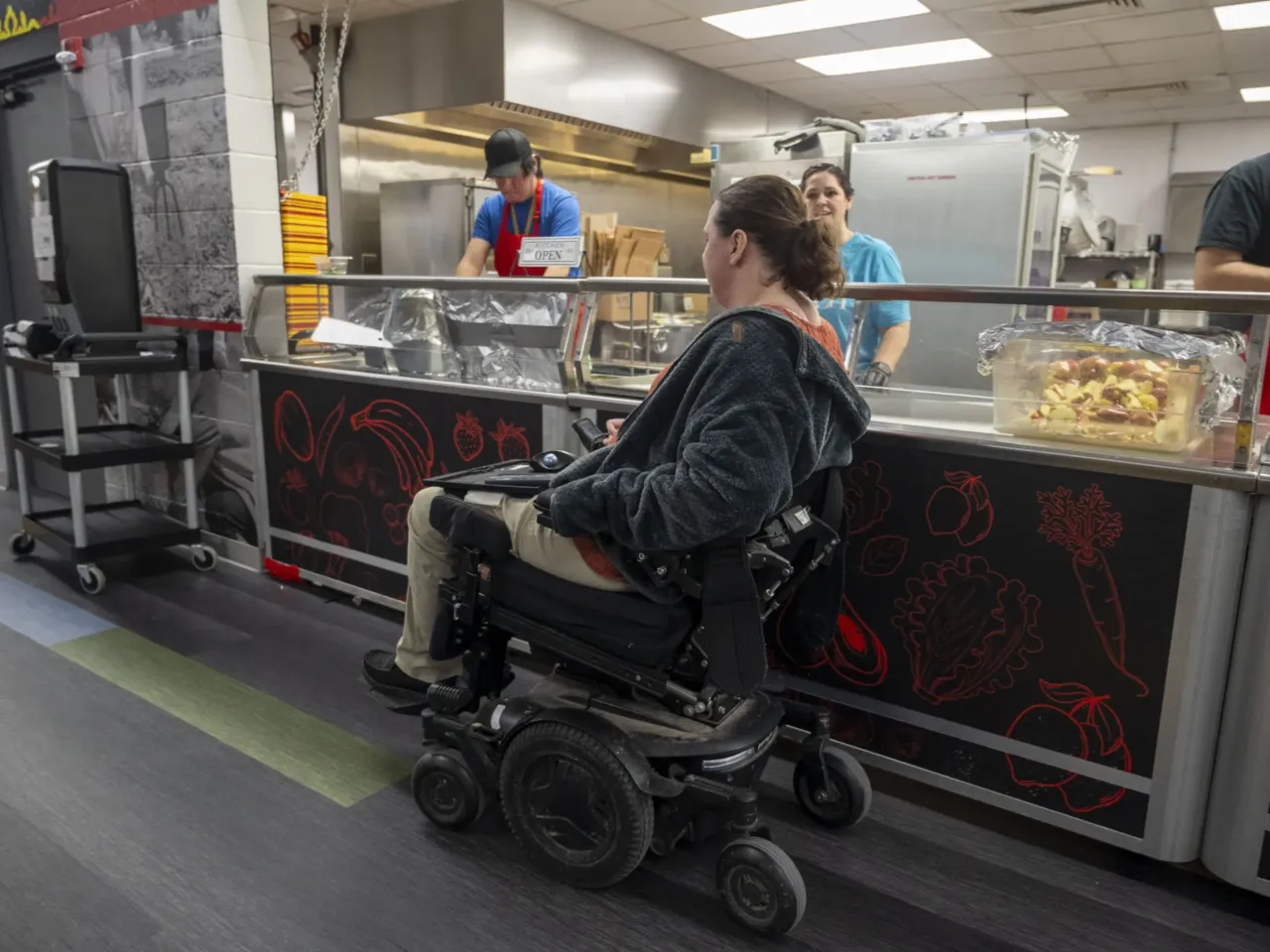 People with disabilities say Medicaid income limits can stifle career advancement 2 Erica Carter makes her way through the cafeteria at the Omaha Nation Public Schools campus, where she works as a finance manager. Carter says she enjoys her job writing grants for one of Nebraska's lowest-income school districts.