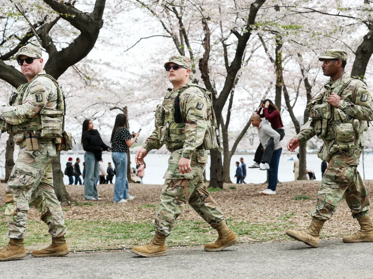 Armed troops have patrolled D.C. for 1 year now. It's challenging democratic norms 2 Members of the National Guard patrol the Tidal Basin as tourists visit the Cherry Blossoms on March 30, 2026 in Washington, DC.